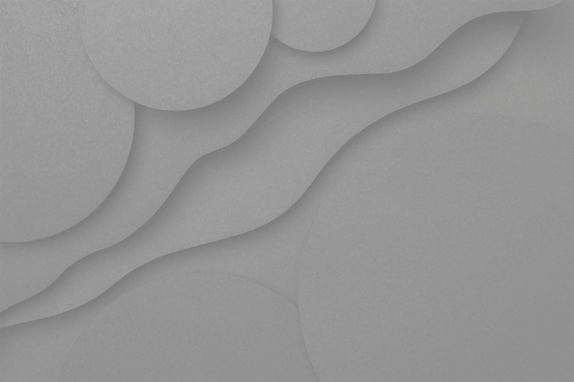 Un arrière-plan texturé avec des cercles superposés et des lignes ondulées. L'image est monochrome, utilisant différentes nuances de gris pour créer de la profondeur et de la dimension. Les cercles et les vagues varient en taille, créant un motif abstrait visuellement intéressant.